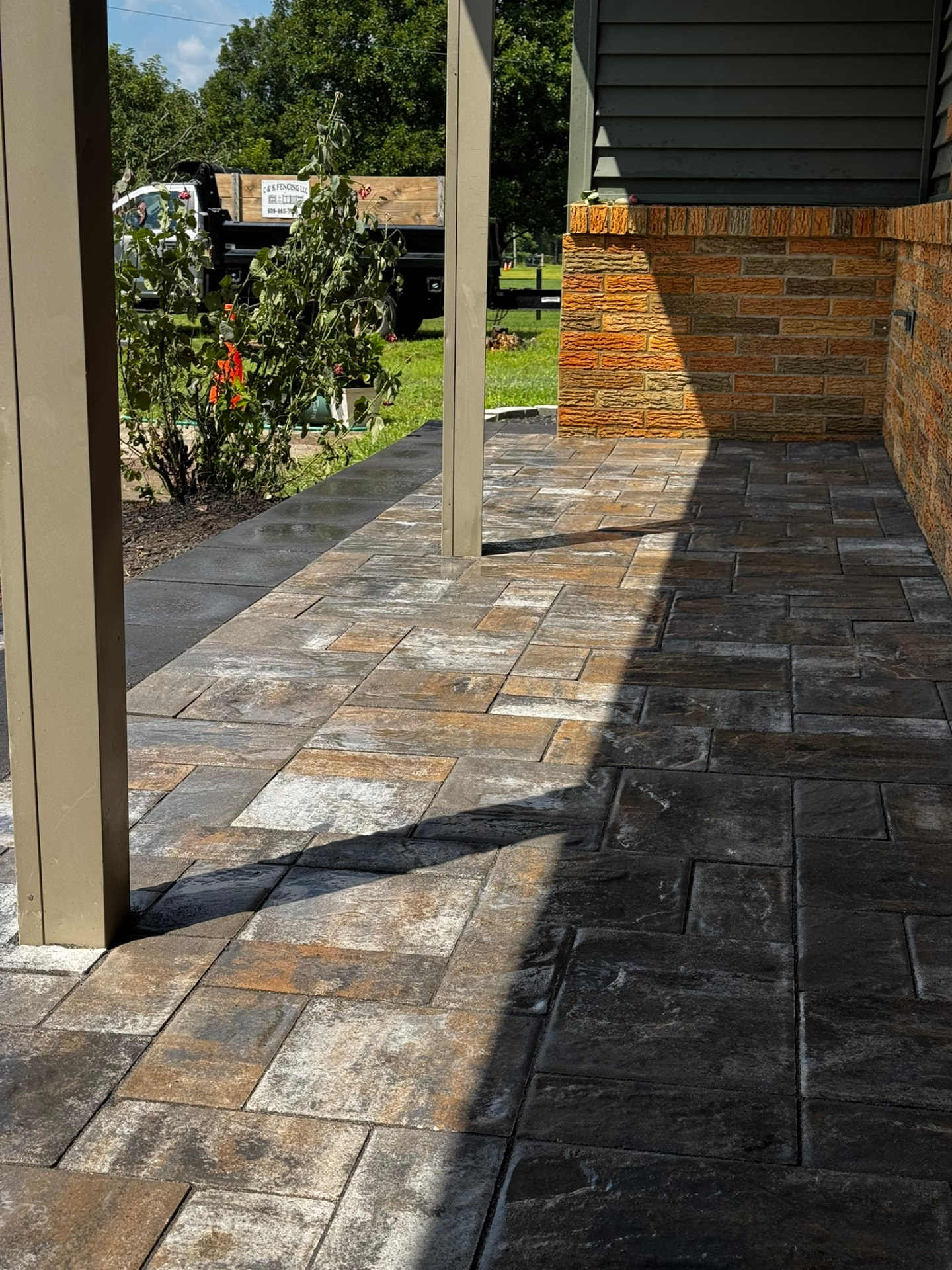 Close-up of variegated large-format paver porch with dark charcoal border banding