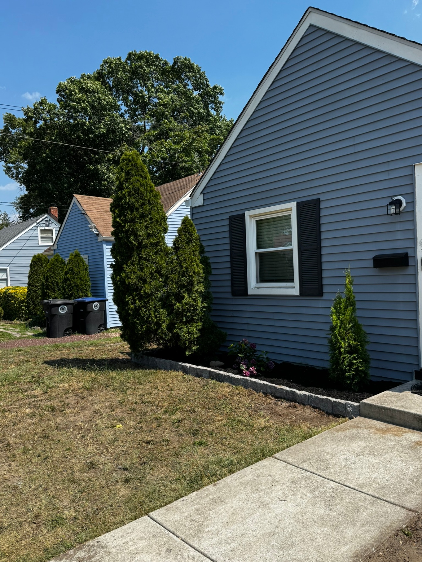 Side foundation bed with mulch, plantings and edgestone border in Lindenwold New Jersey
