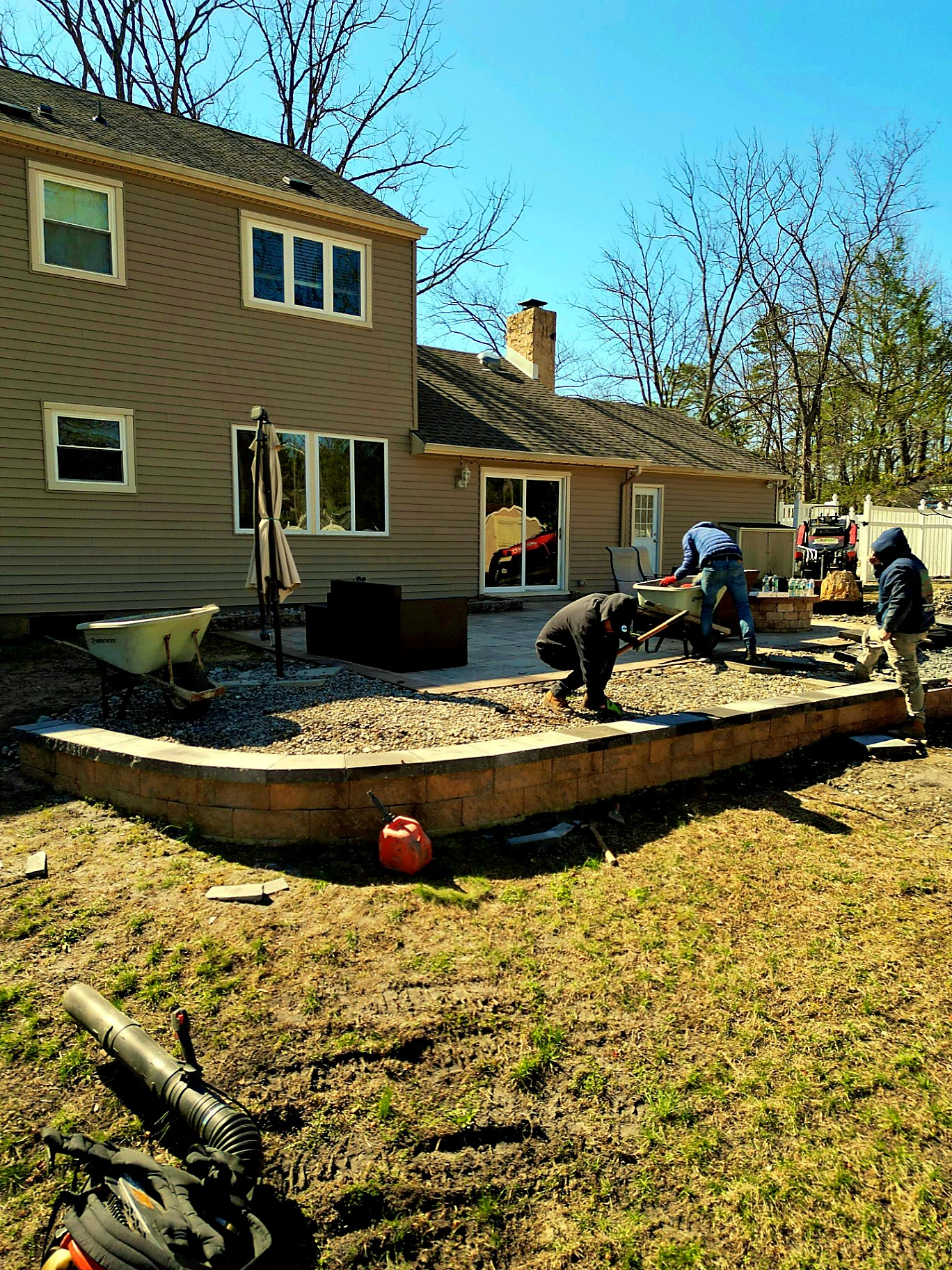 Crew building a retaining wall behind a home in Voorhees New Jersey