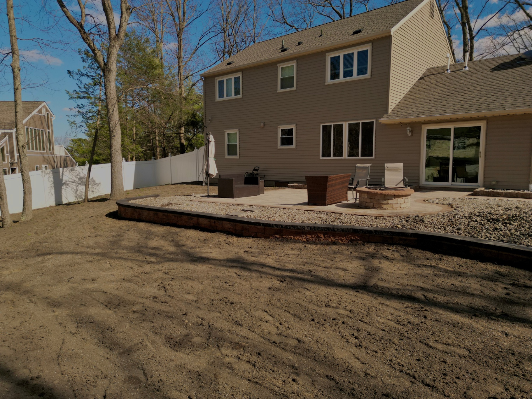 1 Day Retaining Wall Installation & completely re-graded yard with seed. Voorhees NJ. 

