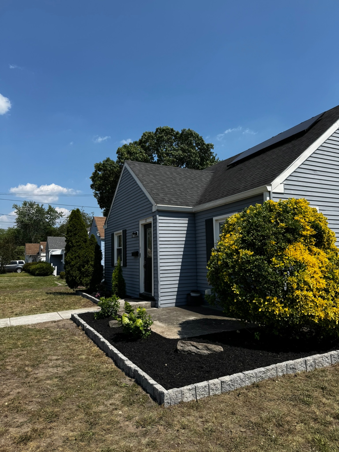 Front foundation bed refreshed with mulch, shrubs and edgestone in Lindenwold New Jersey