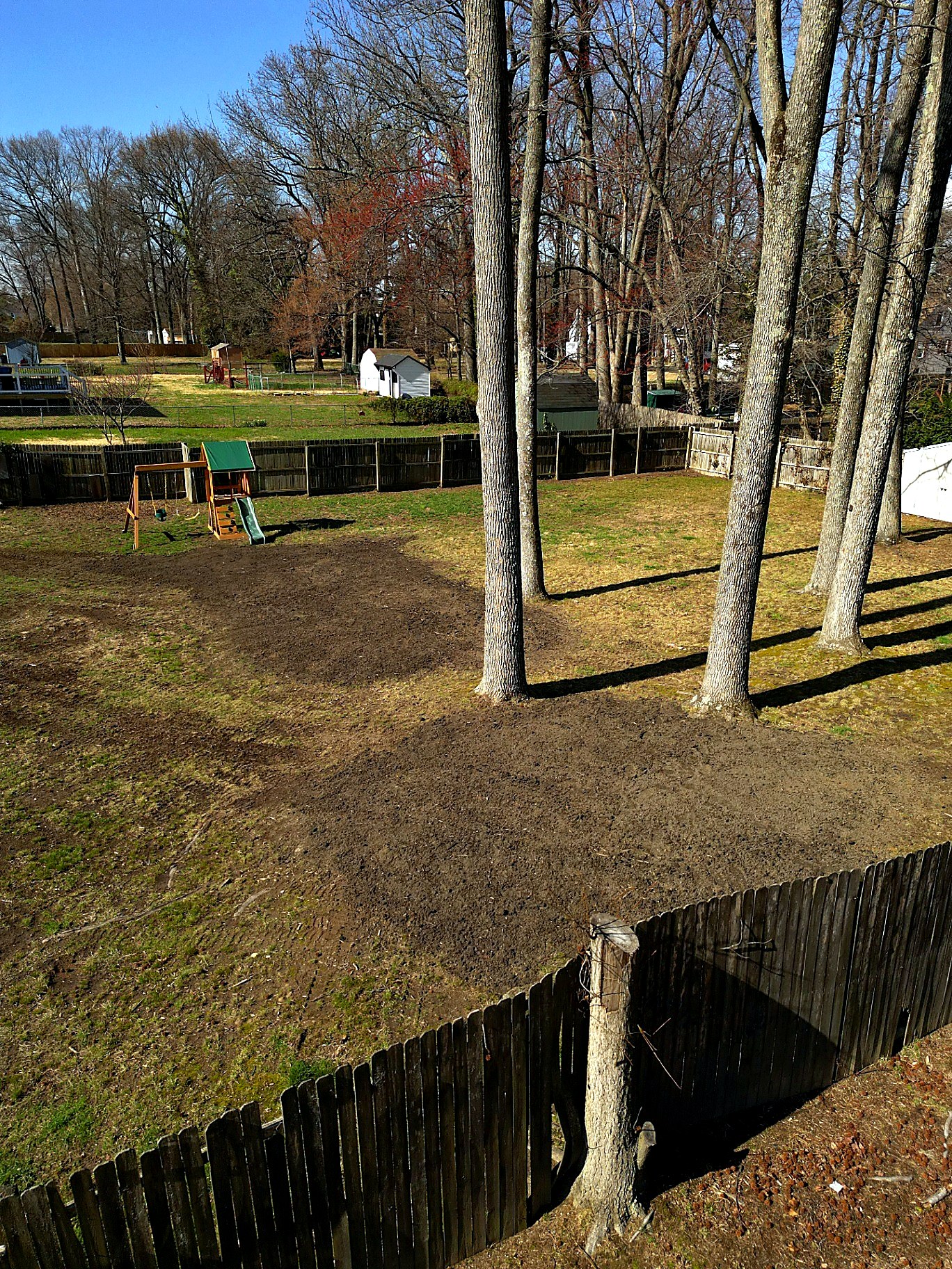Topsoil spread over a backyard after tree removal in New Jersey