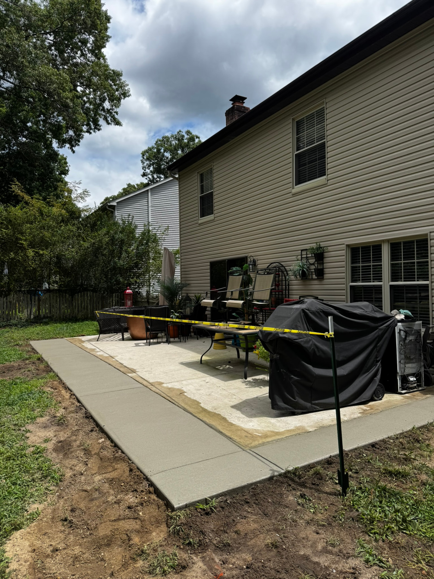 New poured concrete patio extension bordering an existing backyard patio in New Jersey